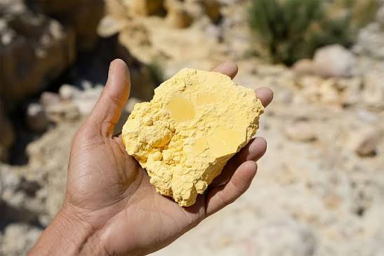 Uranium ore sample held in a hand